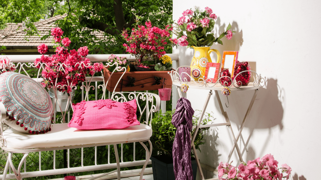 Cheery & bright garden design with pink and red flowers and white bench