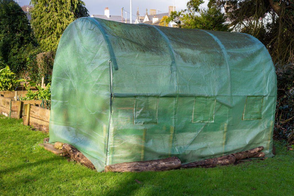 Shade netting over garden greenhouse